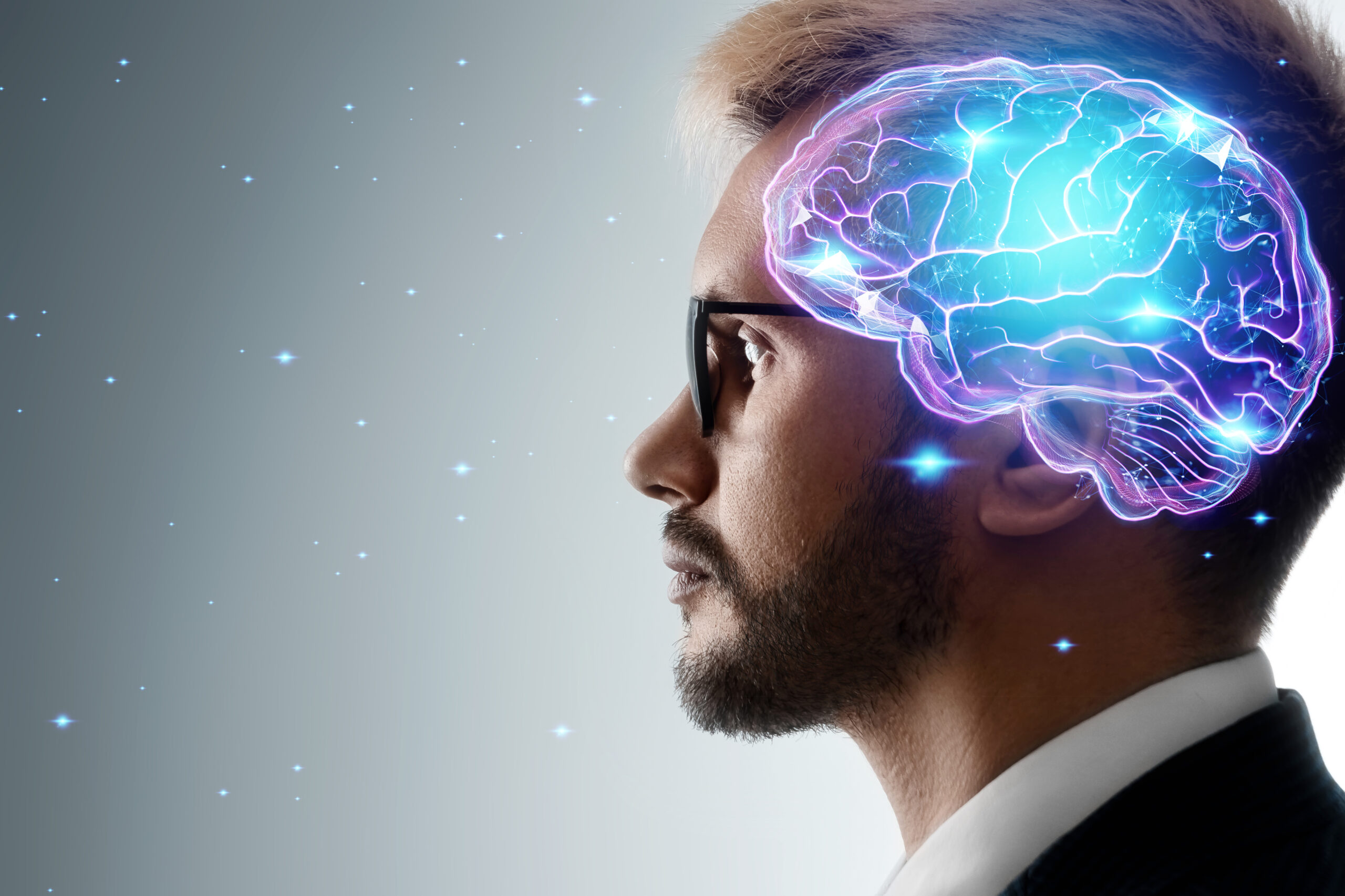 Close up portrait of a man from the side in profile and a hologram of a working brain. The concept of intelligence, brain work, thought process